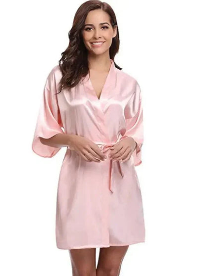 Silk kimono robe in light pink color worn by a woman.
