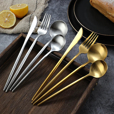 Golden cutlery set with knife, fork, and spoon in stainless steel for elegant dining.