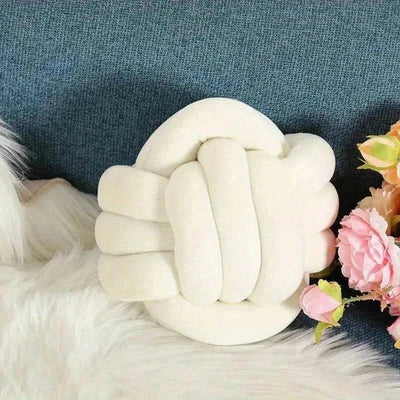 Small round knot ball decorative plush throw pillow with floral decor.