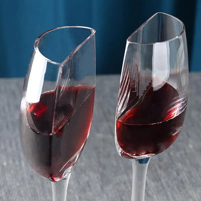 Waterford crystal champagne flutes with red wine and unique cut design.