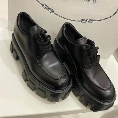 Women's patent leather lace-up loafers with medium heel and rubber outsole.