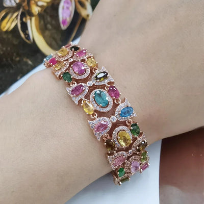 Rose gold bracelet with colorful zirconia stones, luxury wedding jewelry.