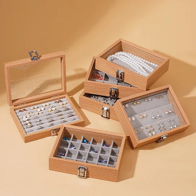 Wooden jewelry box with multiple compartments for rings, earrings, and necklaces.